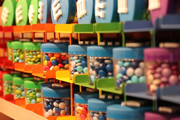 Close-up of colorful candies in containers for sale at store