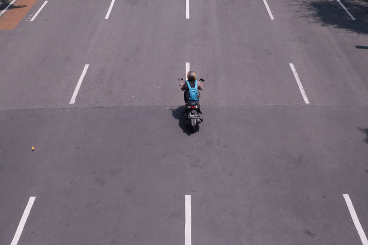 High angle view of man riding motorcycle on road