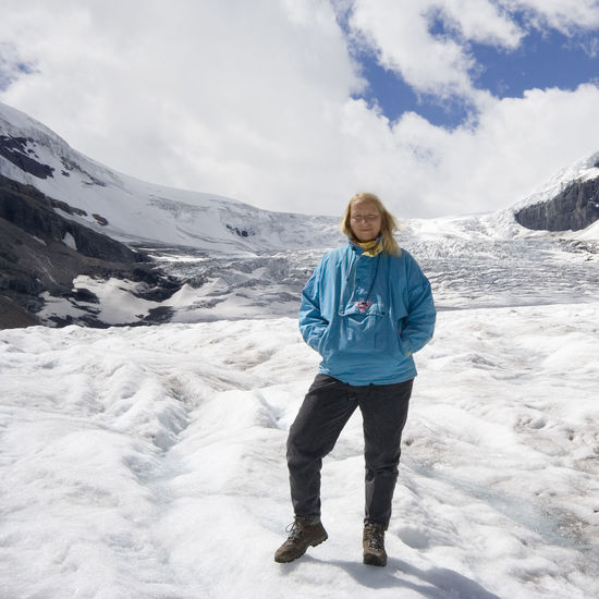 Full length of woman standing at athabasca glacier against sky
