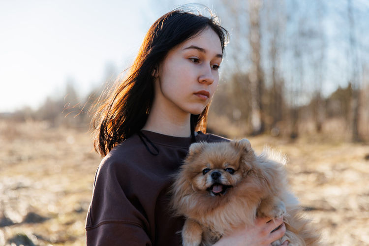 Portrait of young woman with dog