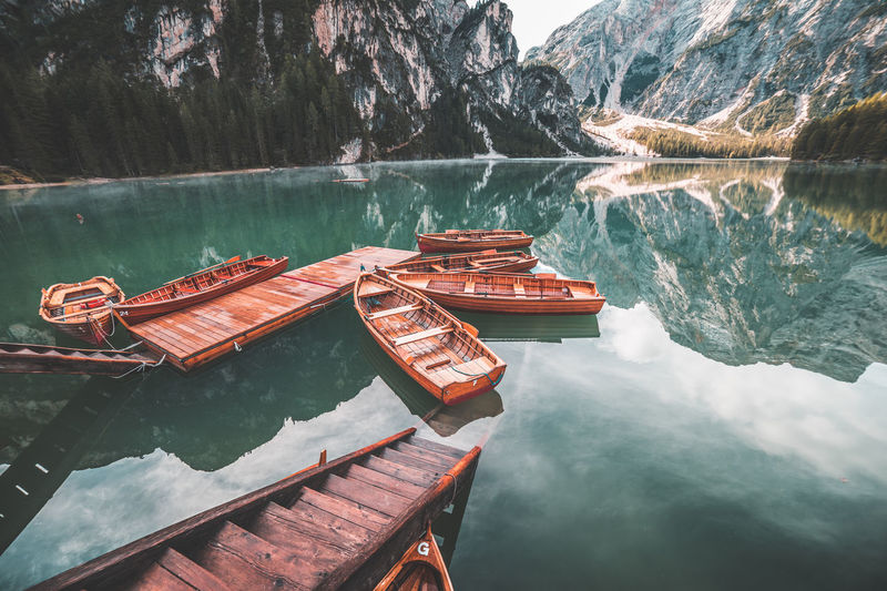 High angle view of boats moored on lake by mountains