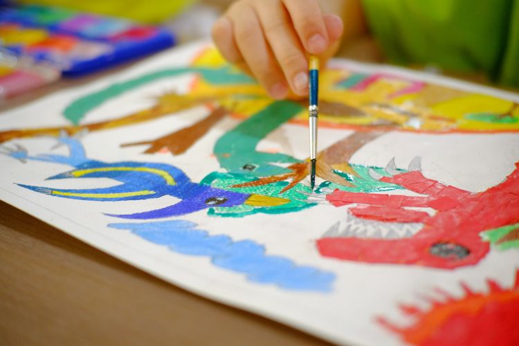 Close-up of hand painting on table