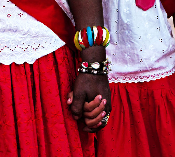 Midsection of couple wearing red traditional clothing