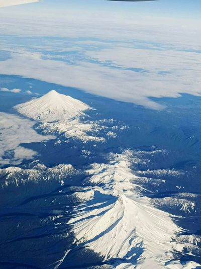 View of the osorno and puntiagudo volcanos from the airplane on fly santiago to punta arenas