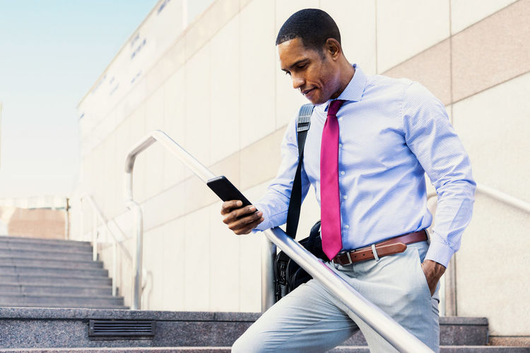 Side view of man using mobile phone