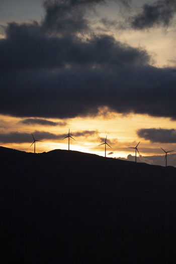 Spain, andalusia, tarifa, wind wheels on mountain at sunrise