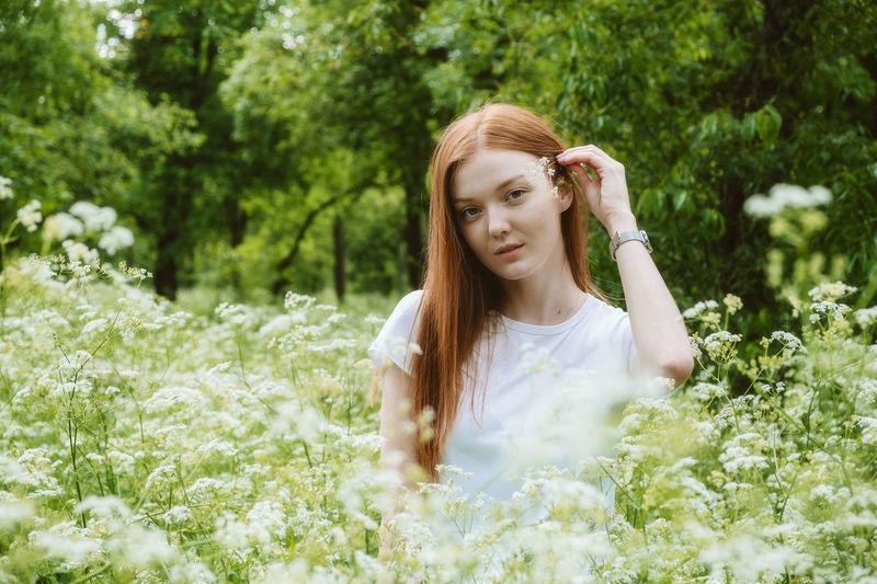 Healing power of nature, benefits of ecotherapy, nature impact wellbeing. happy redhead woman