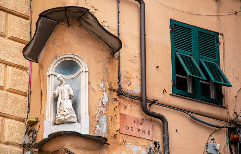 Votive wall shrine and street sign of via di prè, a famous and ancient neighborhood of genoa