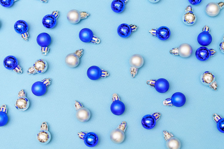 Blue and silver christmas decoration balls baubles on blue background with copy