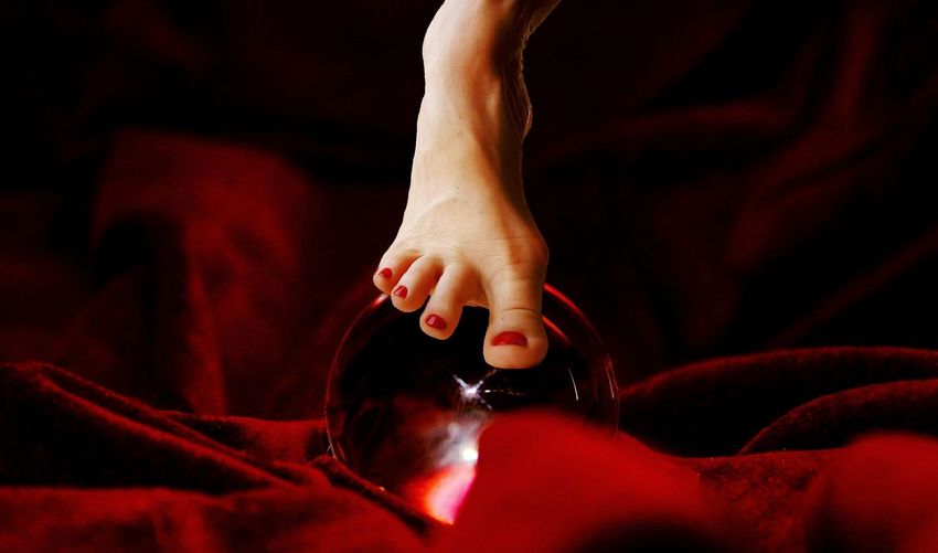 Low section of woman on crystal ball
