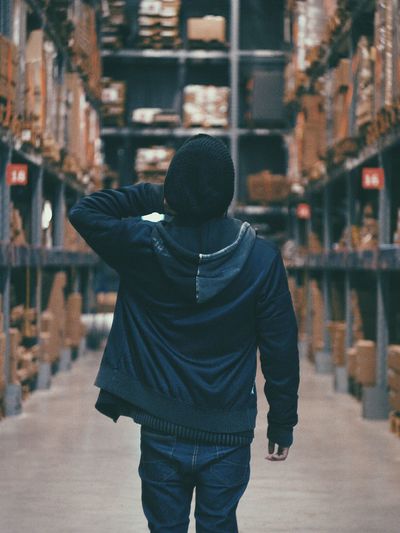 Rear view of man standing in warehouse