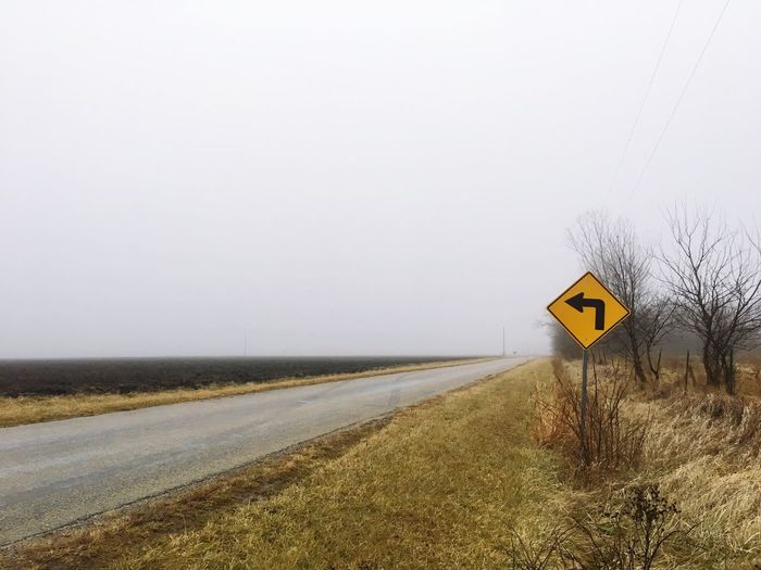 Road sign against clear sky