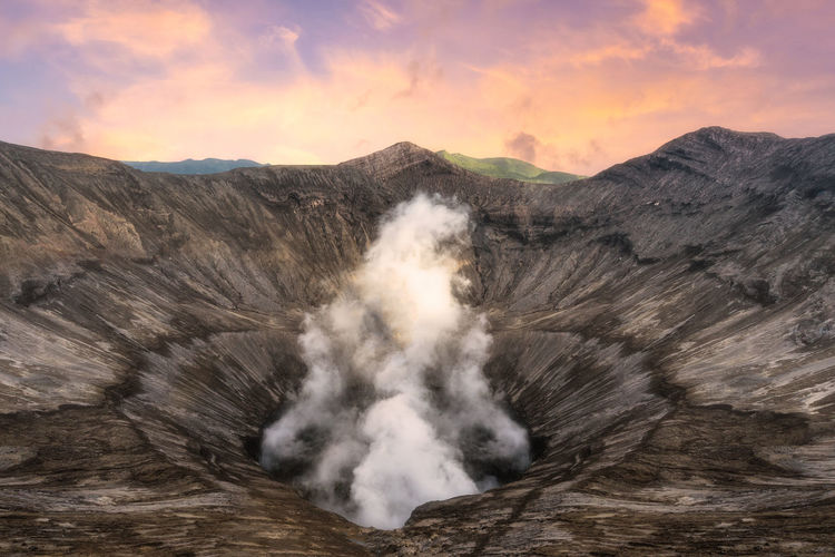 Volcanic crater against sky during sunset