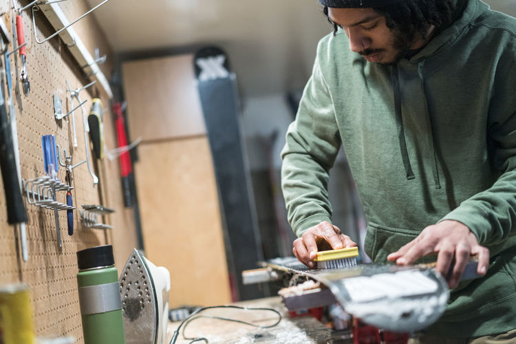 Man waxes his skis in a workshop in lake tahoe, ca