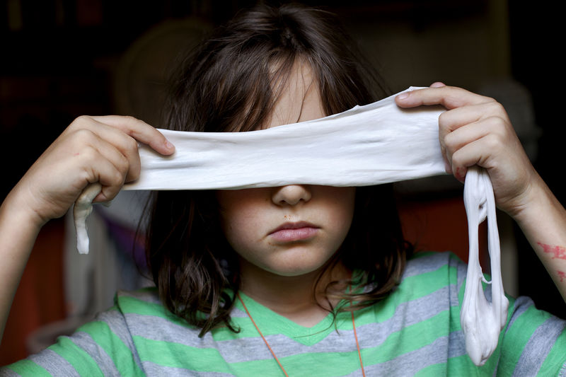 Close-up of girl holding blindfold