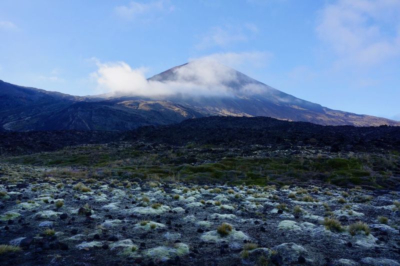 Scenic view of volcanic mountain against sky 