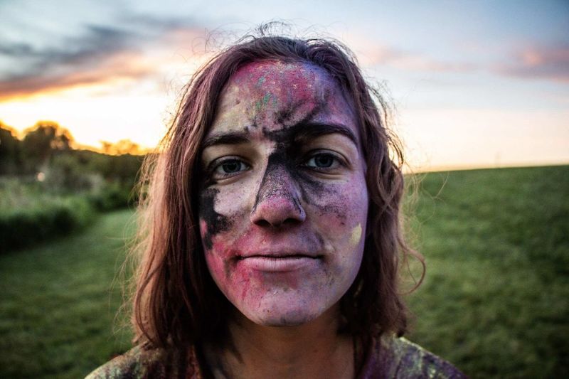Close-up portrait of woman covered in powder paint