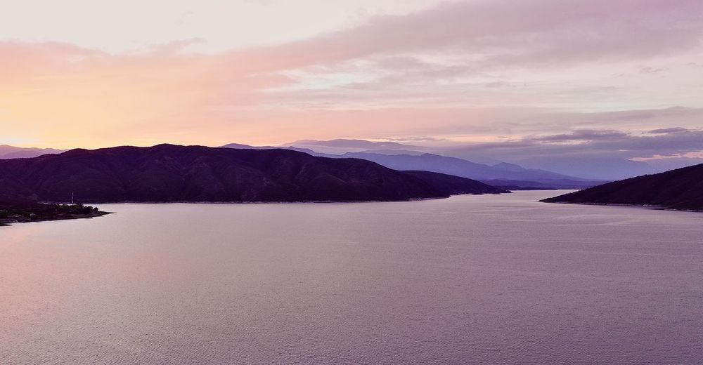 Scenic view of lake against sky during sunset