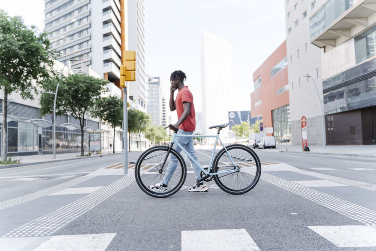 Man with bicycle talking on phone