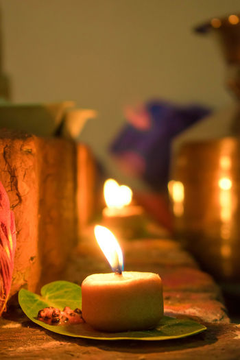 Close-up of lit candles on table