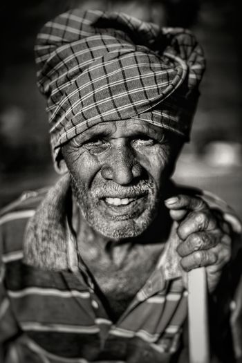 Portrait of mature wrinkled man wearing turban