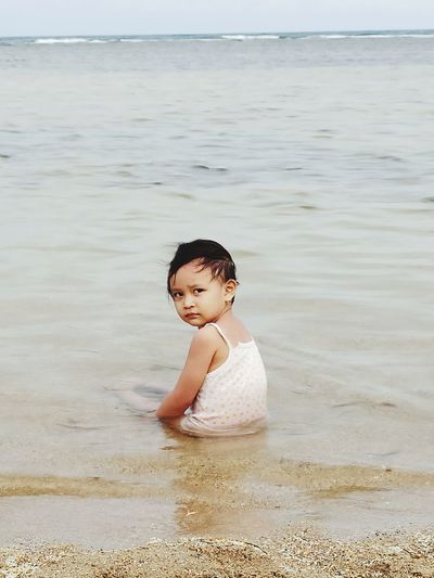 Full length of cute baby girl on beach