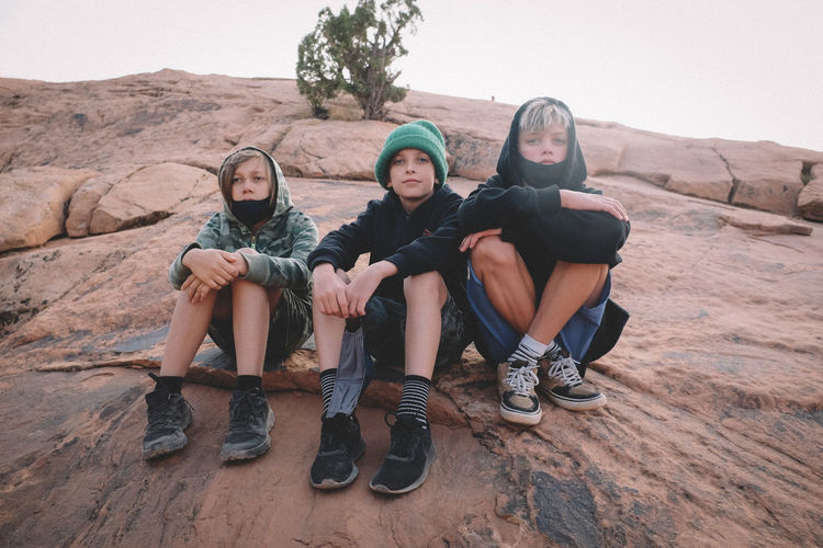 Three young boys on a hike in the desert during covid