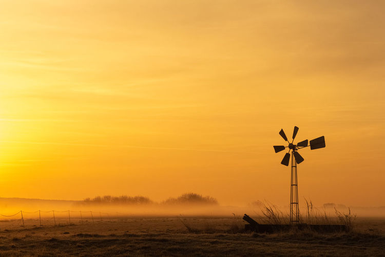 Foggy landscape against sunrise sky with beautiful morning light