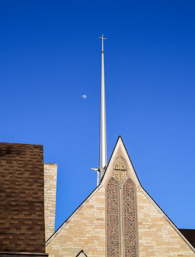 Low angle view of church building against clear blue sky