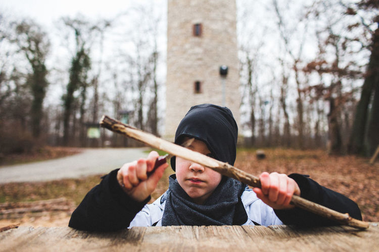 Portrait of boy carving wood