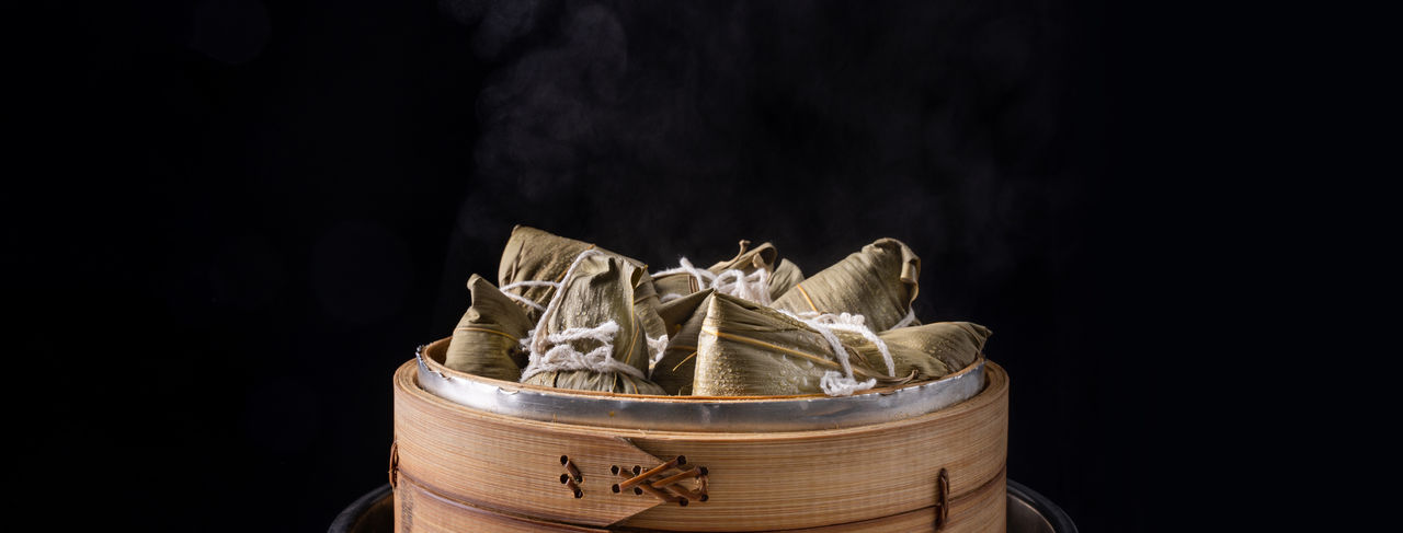 Zongzi rice dumpling for dragon boat festival over dark background.
