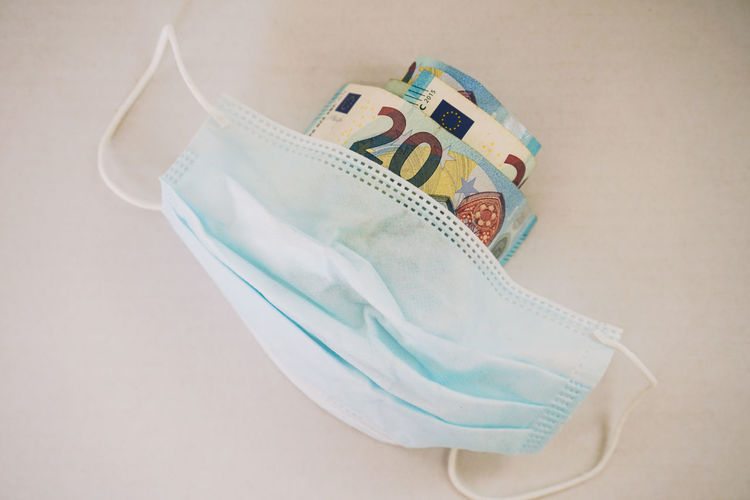 Face mask with 20 euro bills tucked underneath