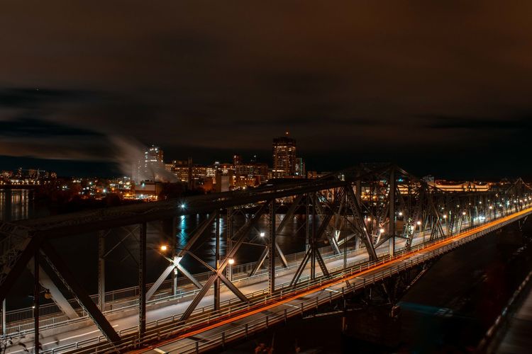 High angle view of illuminated bridge against sky at night