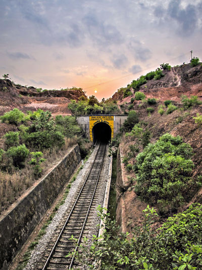 Sunset over the railway line going into tunnel at honavar, karnataka.