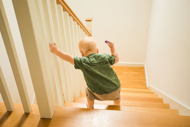 Boy standing on staircase at home