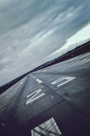Low angle view of airport runway against sky