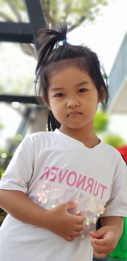 Portrait of cute girl standing outdoors