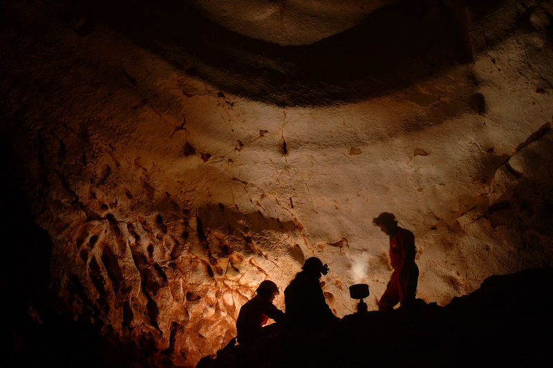 Low angle view of miners working in cave