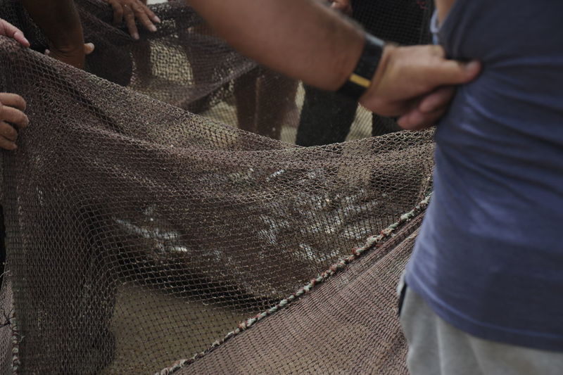 Fishermen holding fishing net