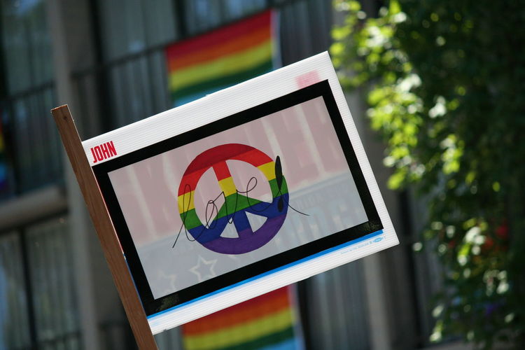 Close-up of peace symbol on banner during gay pride parade