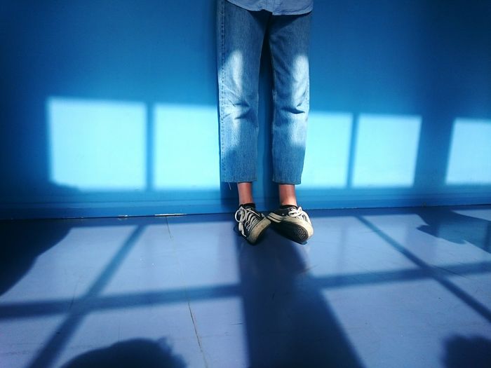 Low section of woman standing on tiled floor
