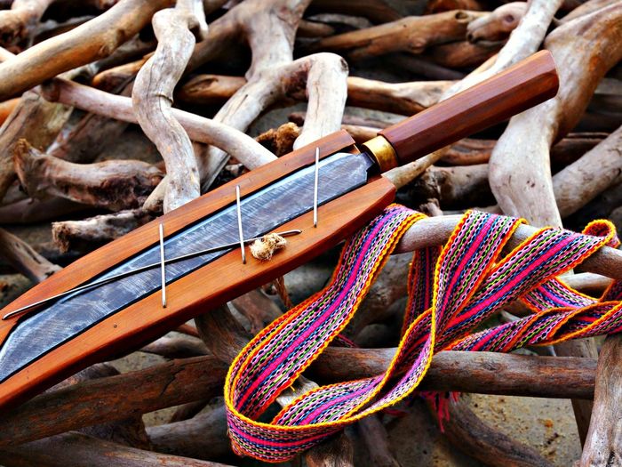 Close-up of knife and ribbon on wood