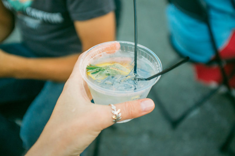 Cropped image of woman holding gin tonic cocktail