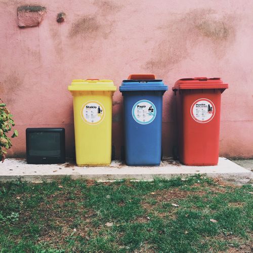 Colorful garbage bins outside house