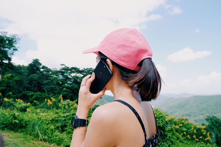 Rear view of woman wearing hat against sky