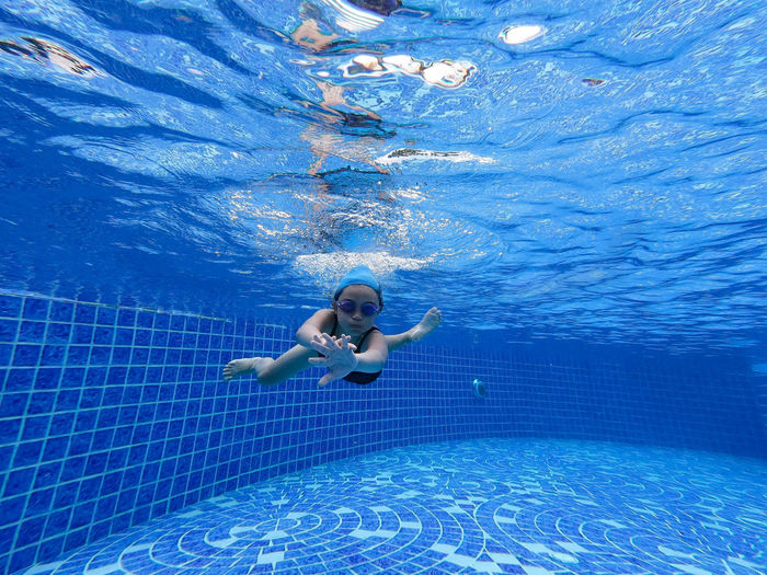 Portrait of girl swimming in pool