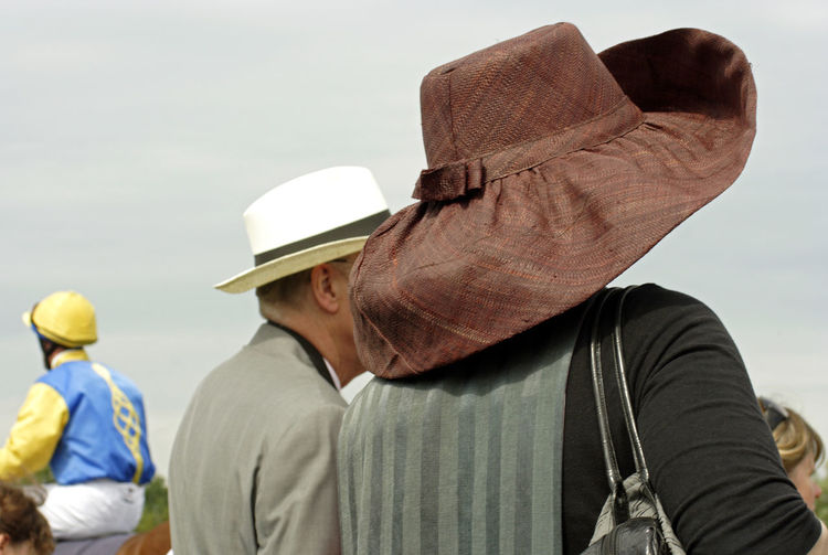 Rear view of man wearing hat against sky