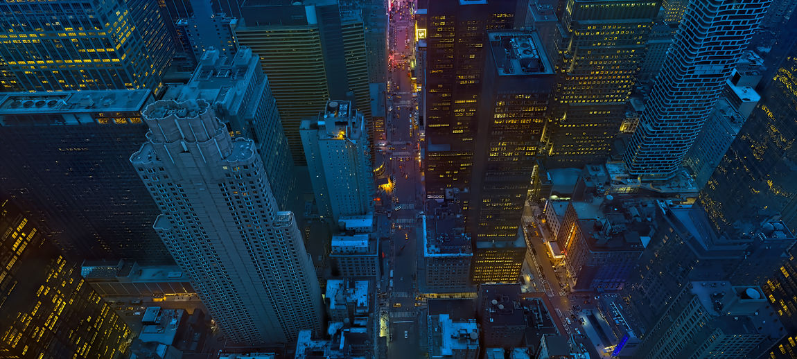Aerial view of illuminated buildings in city at night,new york city