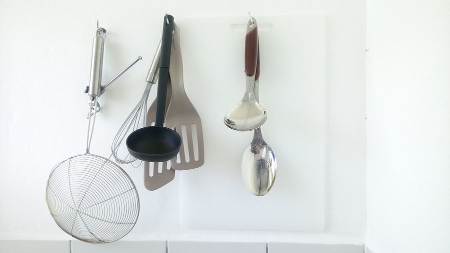 Kitchen utensils on hooks at home