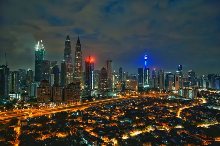 High angle view of city lit up at night